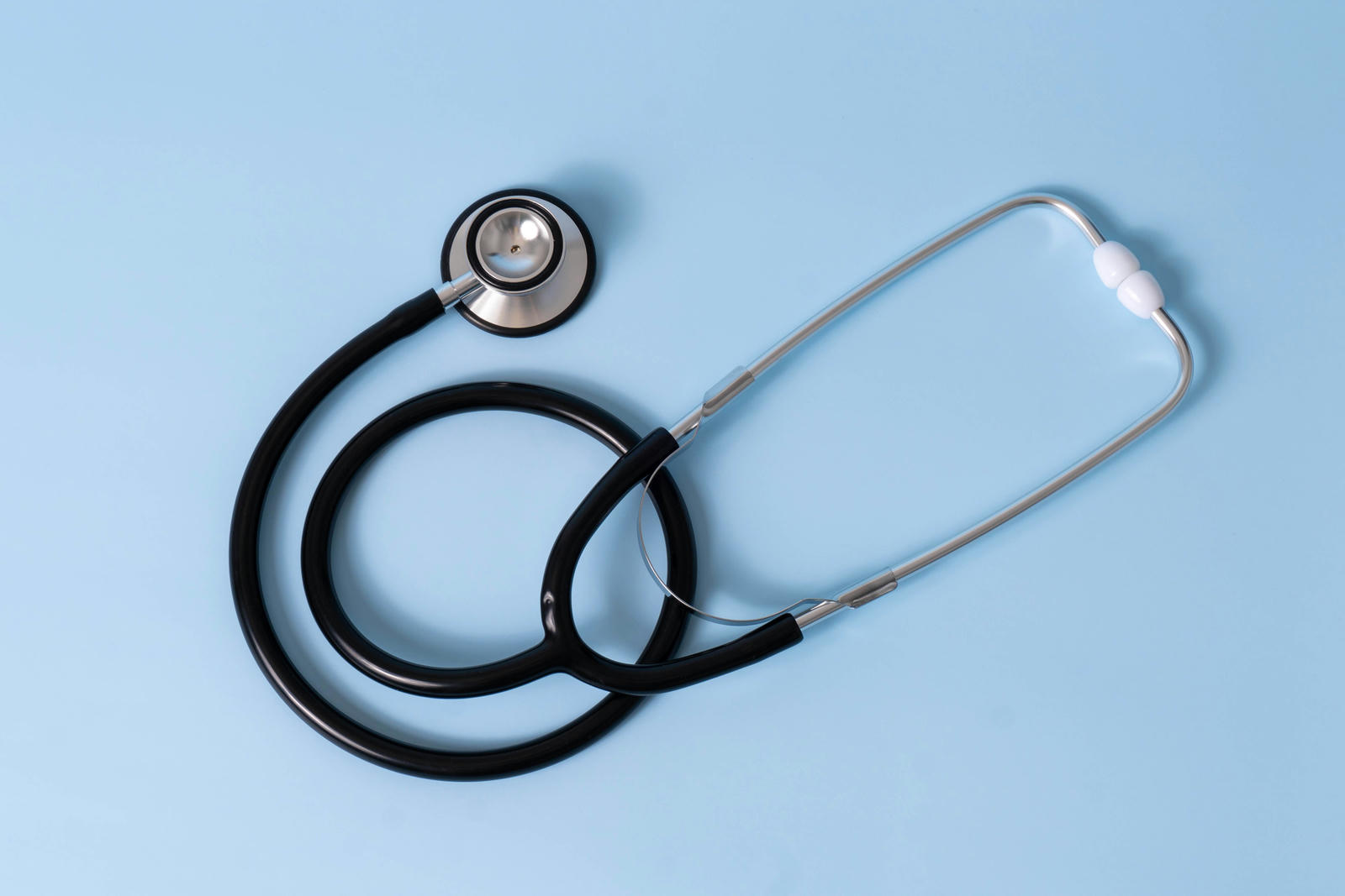 A stethoscope on a light blue background
